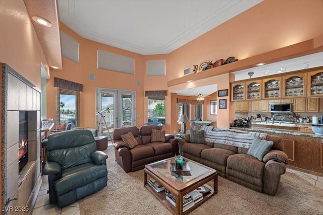 1105 Malachite Ct, Henderson, NV 89011 - living room with light tile patterned floors, a high ceiling, ornamental molding, recessed lighting, and light colored carpet