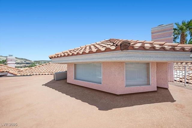 1105 Malachite Ct, Henderson, NV 89011 - view of property exterior with a tile roof and a chimney