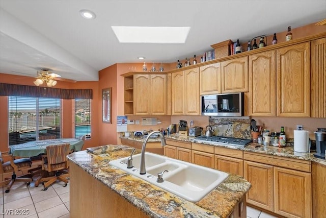 1105 Malachite Ct, Henderson, NV 89011 - kitchen with a sink, stainless steel appliances, light tile patterned flooring, a skylight, and open shelves