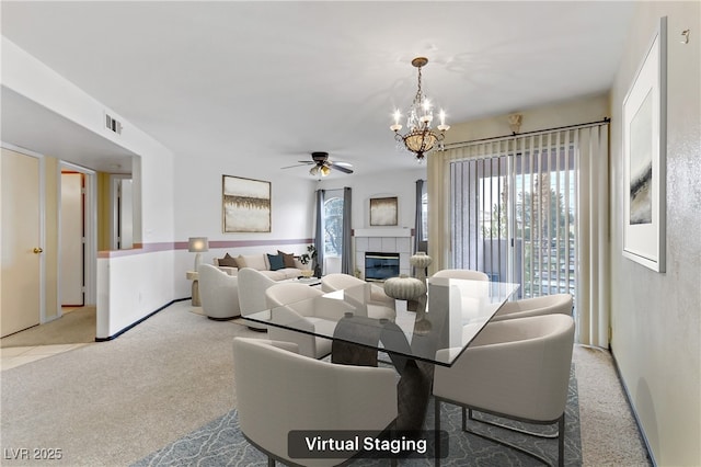 4555 E Sahara Ave Unit 280, Las Vegas, NV 89104 - carpeted dining area featuring a ceiling fan, a tiled fireplace, and a chandelier