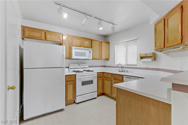 4555 E Sahara Ave Unit 280, Las Vegas, NV 89104 - kitchen featuring white appliances, a peninsula, light floors, light countertops, and rail lighting