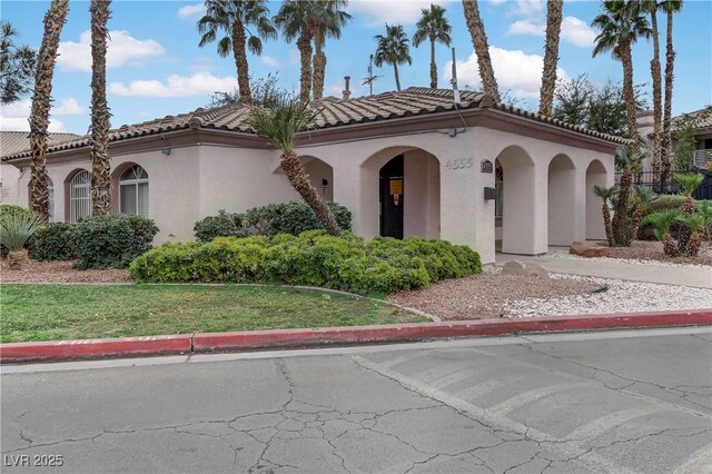 4555 E Sahara Ave Unit 280, Las Vegas, NV 89104 - mediterranean / spanish-style home with stucco siding, a tiled roof, and a front lawn