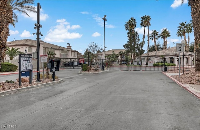 4555 E Sahara Ave Unit 280, Las Vegas, NV 89104 - view of street featuring a gate, a gated entry, curbs, street lights, and traffic signs