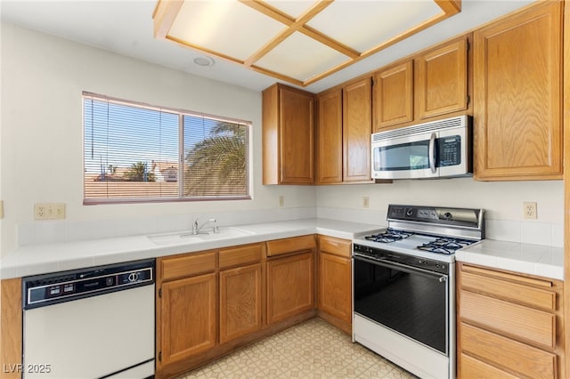 433 Old Palms Dr, Las Vegas, NV 89123 - kitchen featuring white appliances, a sink, light floors, and brown cabinets