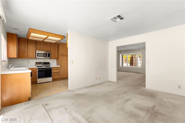 433 Old Palms Dr, Las Vegas, NV 89123 - kitchen with white range with gas stovetop, stainless steel microwave, open floor plan, a sink, and light countertops