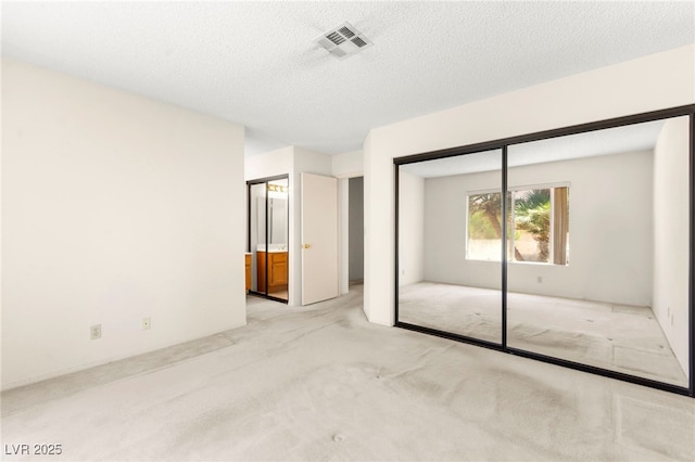 433 Old Palms Dr, Las Vegas, NV 89123 - unfurnished bedroom featuring carpet, a closet, a textured ceiling, and ensuite bathroom