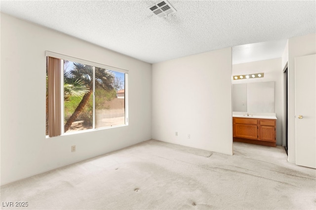 433 Old Palms Dr, Las Vegas, NV 89123 - unfurnished bedroom featuring light colored carpet, a textured ceiling, ensuite bathroom, and a sink