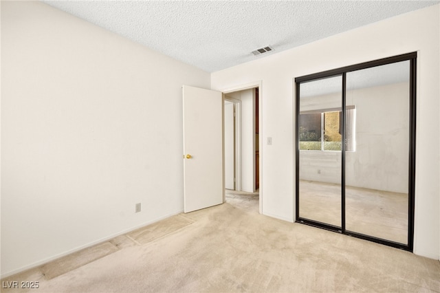 433 Old Palms Dr, Las Vegas, NV 89123 - unfurnished bedroom featuring light colored carpet, a textured ceiling, and a closet