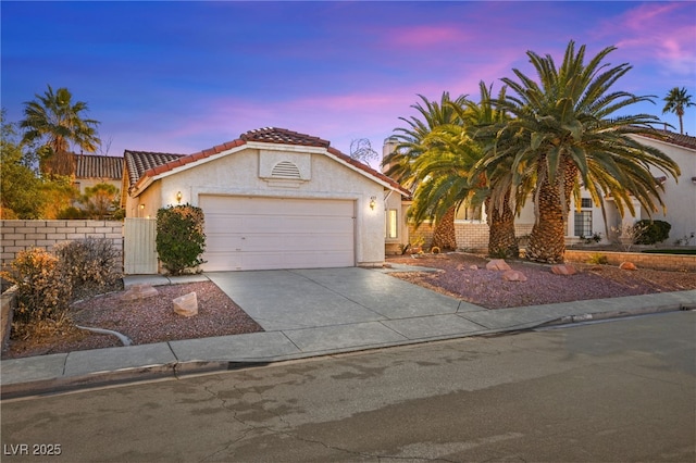 433 Old Palms Dr, Las Vegas, NV 89123 - view of front of house with an attached garage, a tiled roof, driveway, and stucco siding