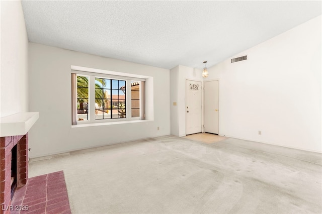433 Old Palms Dr, Las Vegas, NV 89123 - unfurnished living room with carpet floors, a textured ceiling, lofted ceiling, and a brick fireplace