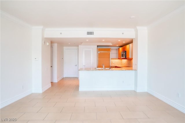 222 Karen Ave Unit 2506, Las Vegas, NV 89109 - kitchen with stainless steel microwave, a sink, a peninsula, light stone counters, and tasteful backsplash