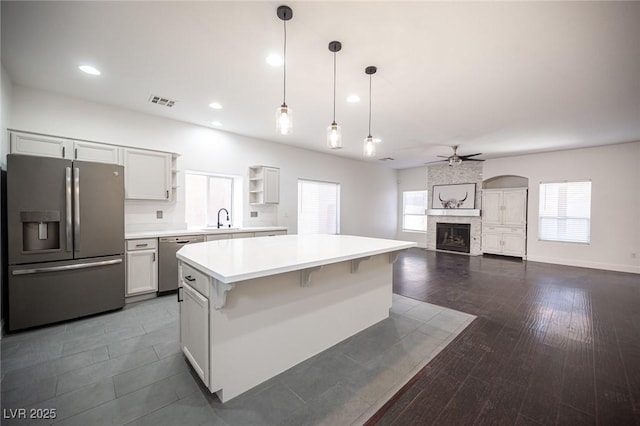 6029 Allanche Ave, Las Vegas, NV 89141 - kitchen with appliances with stainless steel finishes, a sink, ceiling fan, light countertops, and open shelves