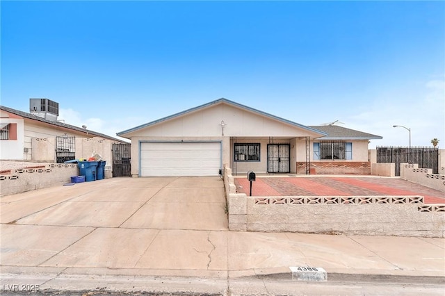 4386 El Cebra Way, Las Vegas, NV 89121 - ranch-style house with concrete driveway, a garage, cooling unit, and brick siding