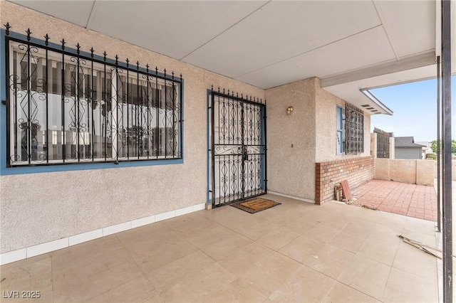 4386 El Cebra Way, Las Vegas, NV 89121 - property entrance featuring brick siding, stucco siding, and a gate