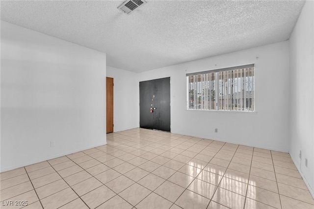4386 El Cebra Way, Las Vegas, NV 89121 - empty room with a textured ceiling and light tile patterned flooring
