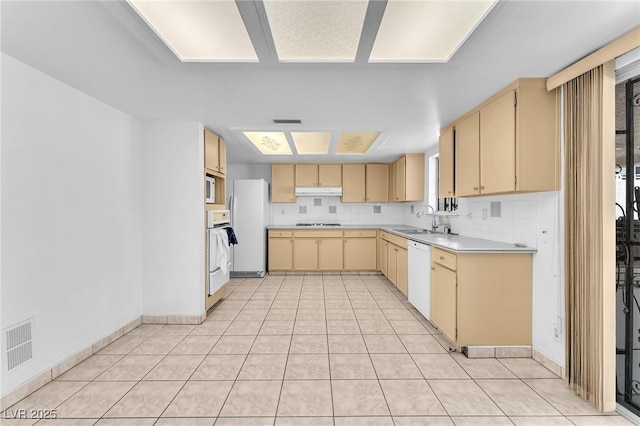 4386 El Cebra Way, Las Vegas, NV 89121 - kitchen featuring white appliances, light countertops, light tile patterned floors, backsplash, and a sink