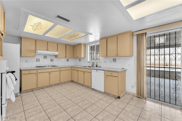4386 El Cebra Way, Las Vegas, NV 89121 - kitchen with white appliances, under cabinet range hood, light countertops, light tile patterned floors, and cream cabinetry