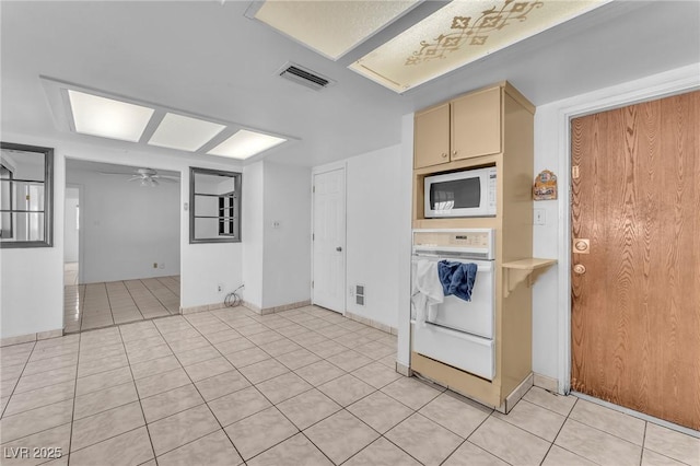 4386 El Cebra Way, Las Vegas, NV 89121 - kitchen featuring white appliances, cream cabinetry, a ceiling fan, light tile patterned floors, and a warming drawer