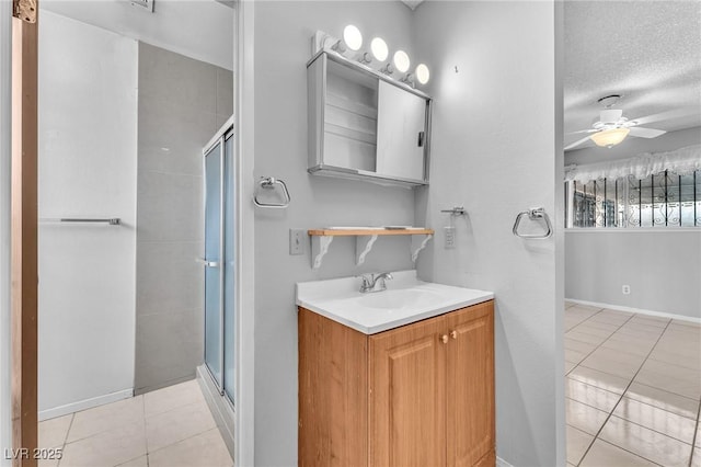 4386 El Cebra Way, Las Vegas, NV 89121 - full bathroom featuring tile patterned flooring, a shower stall, a ceiling fan, vanity, and a textured ceiling