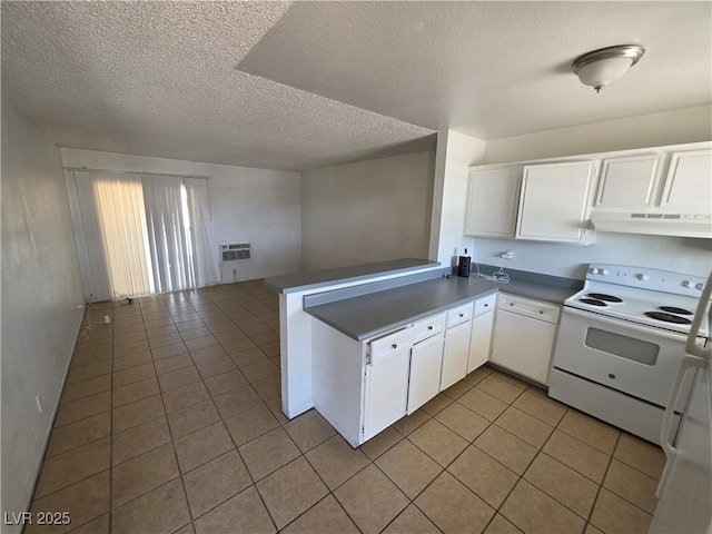 5390 Swenson St Unit 27, Las Vegas, NV 89119 - kitchen with electric range, under cabinet range hood, light tile patterned floors, a textured ceiling, and white cabinetry