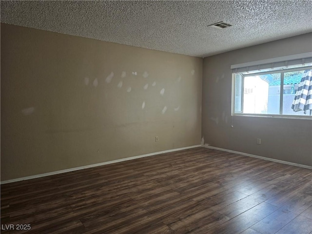 2116 Bavington Dr Unit C, Las Vegas, NV 89108 - spare room with dark wood-style floors, a textured ceiling, and baseboards