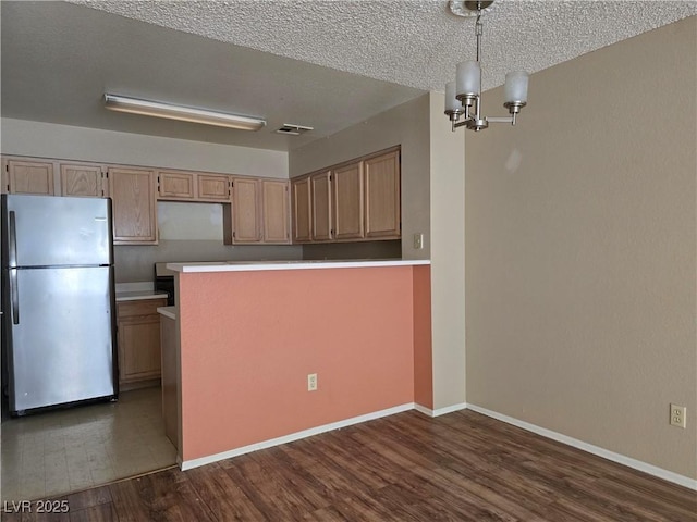 2116 Bavington Dr Unit C, Las Vegas, NV 89108 - kitchen featuring freestanding refrigerator, dark wood-style floors, a chandelier, a textured ceiling, and baseboards