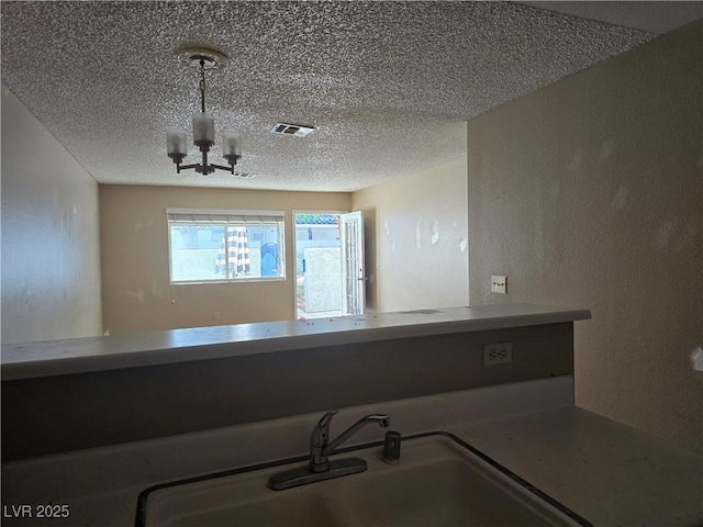 2116 Bavington Dr Unit C, Las Vegas, NV 89108 - detailed view of a textured ceiling, a sink, a chandelier, and a textured wall