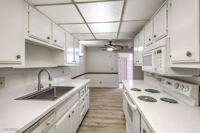 3683 Villa Knolls E Dr, Las Vegas, NV 89120 - kitchen featuring white appliances, a sink, a ceiling fan, white cabinets, and light wood-style flooring