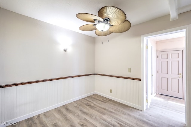 3683 Villa Knolls E Dr, Las Vegas, NV 89120 - unfurnished room with light wood finished floors, a ceiling fan, wainscoting, and baseboards