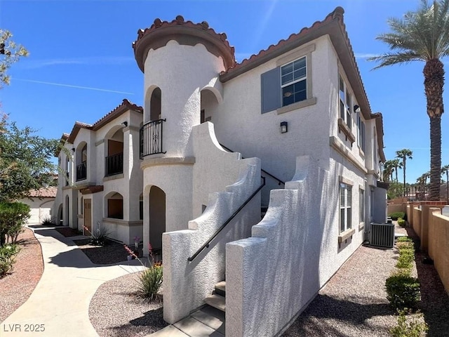50 Aura De Blanco St Unit 18204, Henderson, NV 89074 - view of home's exterior with stucco siding, a tiled roof, and cooling unit