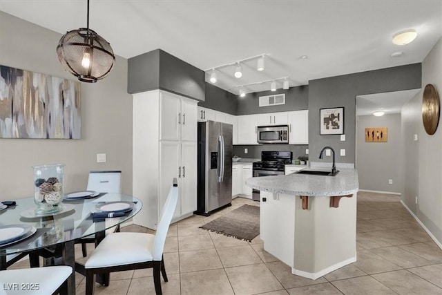 50 Aura De Blanco St Unit 18204, Henderson, NV 89074 - kitchen featuring stainless steel appliances, a sink, a peninsula, and light tile patterned floors