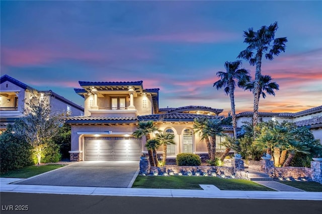 1972 Alcova Ridge Dr, Las Vegas, NV 89135 - mediterranean / spanish-style home with a balcony, stucco siding, concrete driveway, a garage, and a tile roof