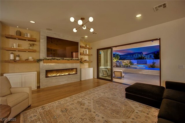 1972 Alcova Ridge Dr, Las Vegas, NV 89135 - living room with wood finished floors, a large fireplace, and recessed lighting