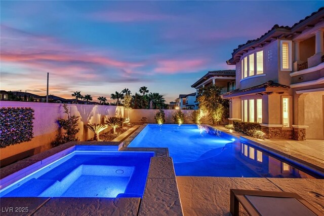 1972 Alcova Ridge Dr, Las Vegas, NV 89135 - pool at dusk featuring an in-ground hot tub and a fenced backyard