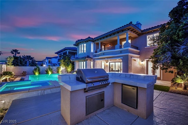 1972 Alcova Ridge Dr, Las Vegas, NV 89135 - patio terrace at dusk featuring a balcony, an in-ground hot tub, and a patio