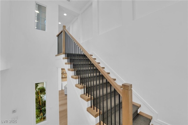 1972 Alcova Ridge Dr, Las Vegas, NV 89135 - staircase with a high ceiling, wood finished floors, and recessed lighting