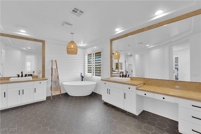 1972 Alcova Ridge Dr, Las Vegas, NV 89135 - full bathroom featuring two vanities, recessed lighting, a soaking tub, tile patterned floors, and tile walls