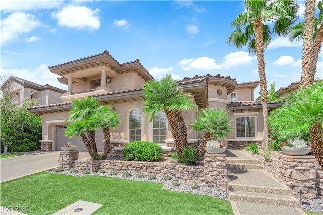 1972 Alcova Ridge Dr, Las Vegas, NV 89135 - mediterranean / spanish-style house featuring stucco siding, driveway, stone siding, a front yard, and a balcony