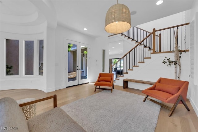 1972 Alcova Ridge Dr, Las Vegas, NV 89135 - living room featuring wood finished floors, stairs, recessed lighting, baseboards, and french doors