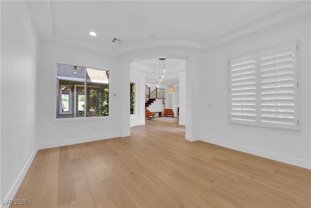 1972 Alcova Ridge Dr, Las Vegas, NV 89135 - empty room with arched walkways, light wood finished floors, stairs, baseboards, and recessed lighting