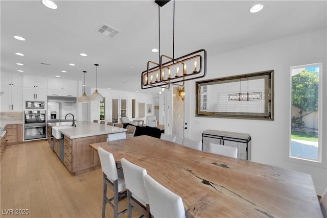 1972 Alcova Ridge Dr, Las Vegas, NV 89135 - dining space with healthy amount of natural light, recessed lighting, light wood-type flooring, and a chandelier