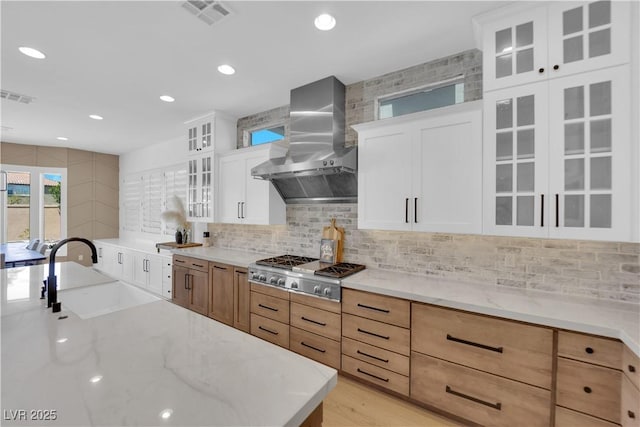 1972 Alcova Ridge Dr, Las Vegas, NV 89135 - kitchen with wall chimney exhaust hood, a sink, stainless steel gas stovetop, light stone countertops, and recessed lighting