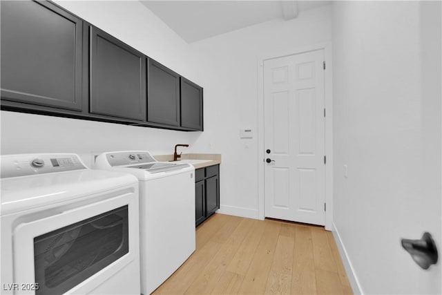 1972 Alcova Ridge Dr, Las Vegas, NV 89135 - laundry room with cabinet space, washing machine and clothes dryer, light wood-style floors, and baseboards