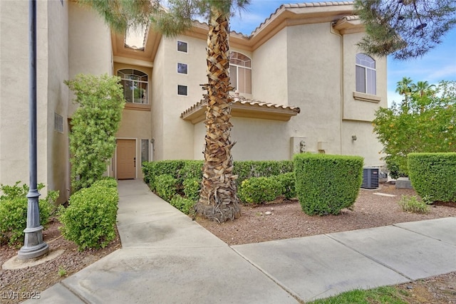2050 W Warm Springs Rd Unit 823, Henderson, NV 89014 - view of front of property featuring stucco siding, a tile roof, and central AC
