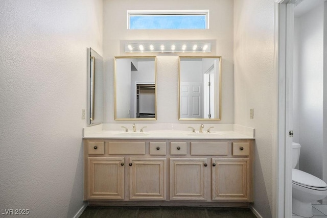 9524 Quail Ridge Dr, Las Vegas, NV 89134 - full bath with double vanity, toilet, baseboards, and a textured wall
