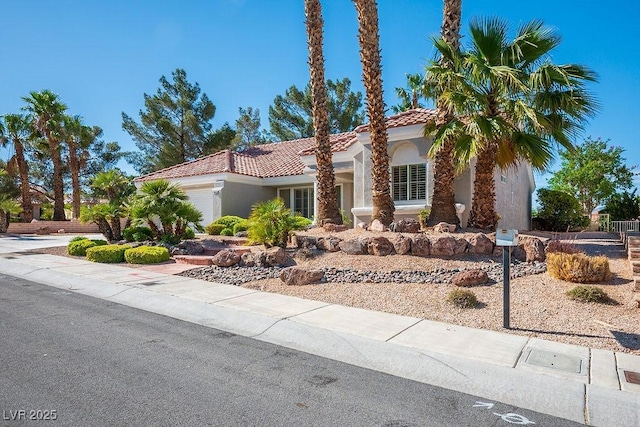 9524 Quail Ridge Dr, Las Vegas, NV 89134 - mediterranean / spanish-style house featuring an attached garage, stucco siding, and a tile roof