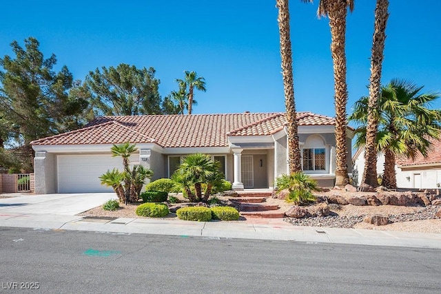 9524 Quail Ridge Dr, Las Vegas, NV 89134 - mediterranean / spanish house with stucco siding, an attached garage, a tile roof, and concrete driveway