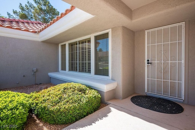9524 Quail Ridge Dr, Las Vegas, NV 89134 - doorway to property with stucco siding and a tiled roof