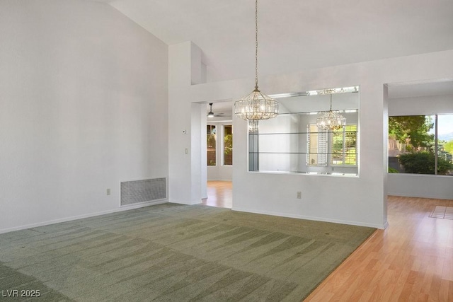 9524 Quail Ridge Dr, Las Vegas, NV 89134 - unfurnished dining area with a chandelier, vaulted ceiling, baseboards, and wood finished floors