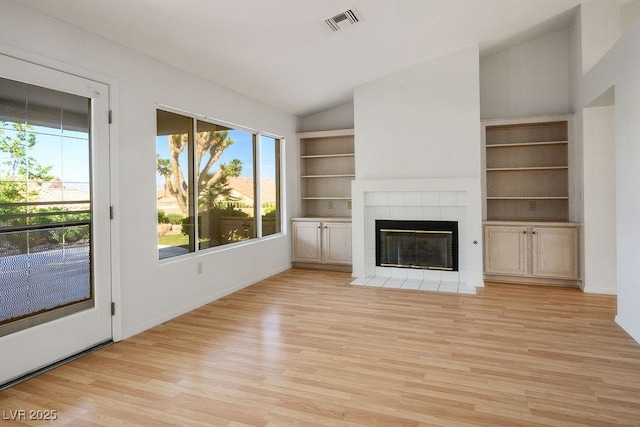 9524 Quail Ridge Dr, Las Vegas, NV 89134 - unfurnished living room with light wood finished floors, a tiled fireplace, built in features, high vaulted ceiling, and baseboards